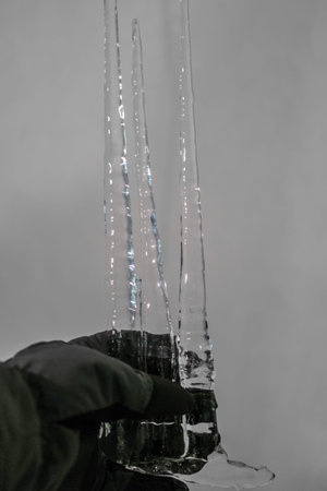 Three big icicles in a gloved hand