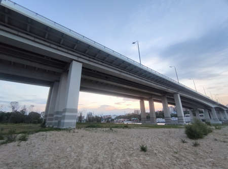 Automobile bridge over the river in the evening. Sandy shoreの写真素材