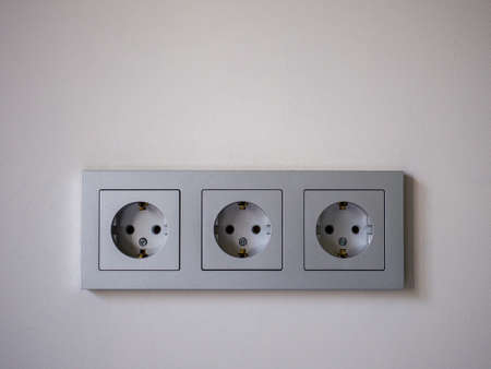 Close-up of a gray three module electrical socket.の写真素材