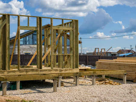 The process of building a private wooden-frame house. Under construction.