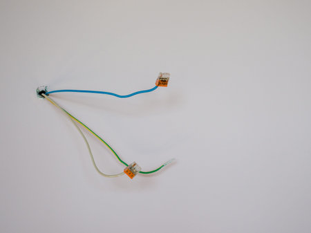 Electrical wires sticking out of the wall to connect the lamp.