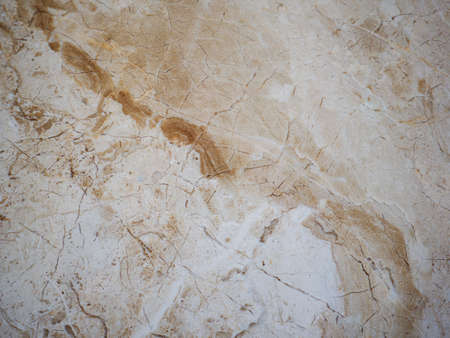 Beige marble background with light brown inclusions.の写真素材