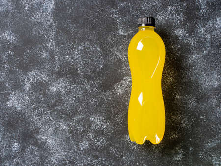 Isotonic energy drink with L-carnitine. Bottle with yellow transparent liquid, sport beverage. Top veiw.の写真素材