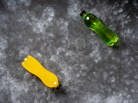 Isotonic energy drink with L-carnitine. Bottles with yellow and green transparent liquid....