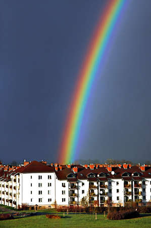 Beautiful, colorful rainbow above housing estateの写真素材