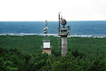 Military radar tower  in the forest near the sea shoreの写真素材