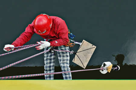 Industrial worker hanging on a rope from a bridge.Reflection in the water.の写真素材