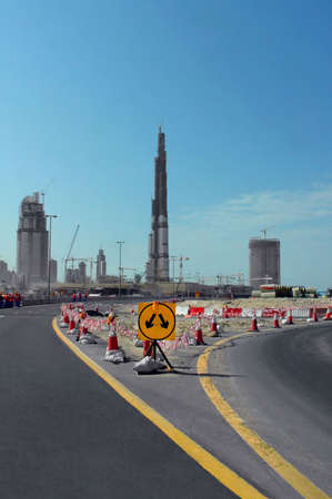World's tallest building, Burj Dubai - 818m 162 flors. Two roads and direction sign in the middleのeditorial素材