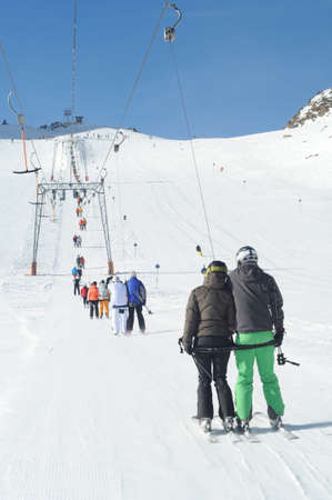 T bar ski lift pulling skiers up the slope. Perfect winter in European Alps.の写真素材