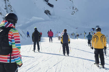Skiers having fun on wide slopes of Austrian glacier in Solden.の写真素材