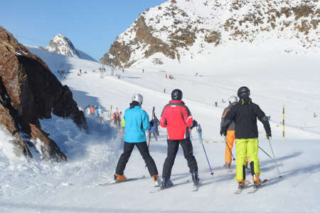 Skiers having fun on wide slopes of Austrian glacier in Solden.の写真素材