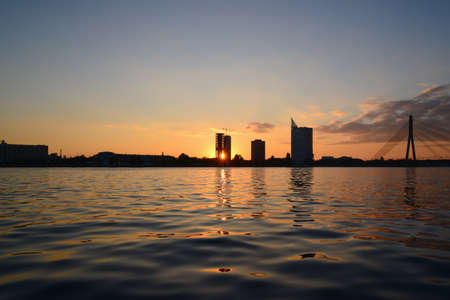 Sunset at quay - sun ray through buildingの写真素材