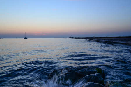 sunset at pier  - water splashの写真素材