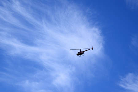 Helicopter in a blue skyの写真素材