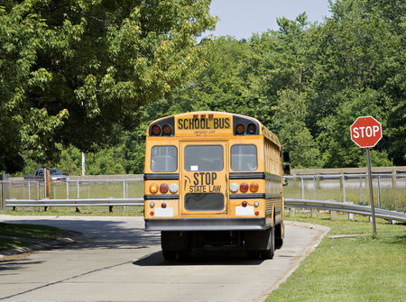 School Bus stopped at a neighborhood stop sign.の写真素材
