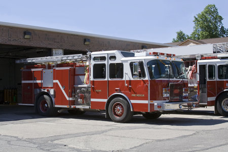 Firetrucks parked in front of firestation ready for action.