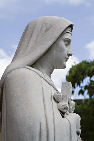 Statue of Mary or a Nun - scenic background.の写真素材