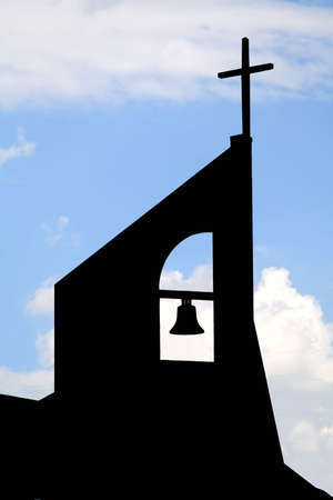 Black silhouette of a church against it's original background.の写真素材