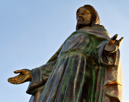 Statue of Jesus made of cooper against a blue sky