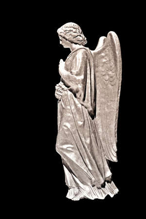 A stone statue of an angel  on black background- special effects applied.の写真素材