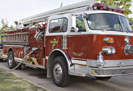 Red hook and ladder fire truck. Hose connecte for service.