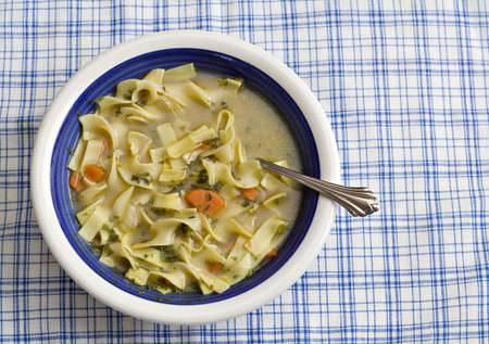 A bowl of homemade chicen soup.の写真素材
