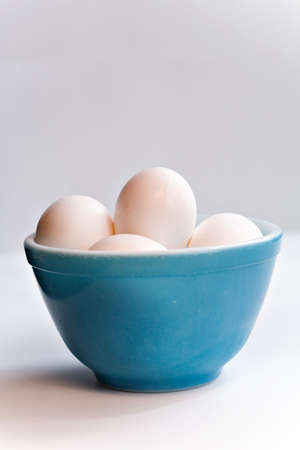 Eggs in an old blue bowl.の写真素材