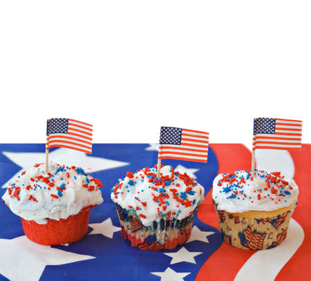 Three American themed cupcakes topped with flags. の写真素材