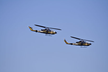 Two U.S. Army helicopters fly in formation at an airshow in Cleveland Ohioの写真素材