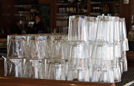 Drinking Glasses stacked and ready for happy hour at a bar.の写真素材