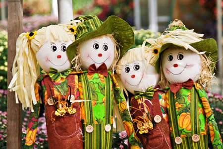 Four scarecrows boys and girls smiling.の写真素材