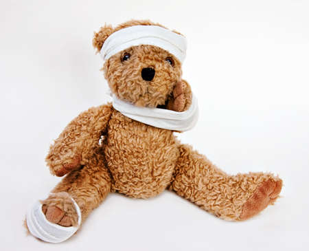 Bear with bandages on head, arm, foot.の写真素材