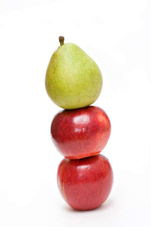 Two apples and a pear stacked on white background. の写真素材