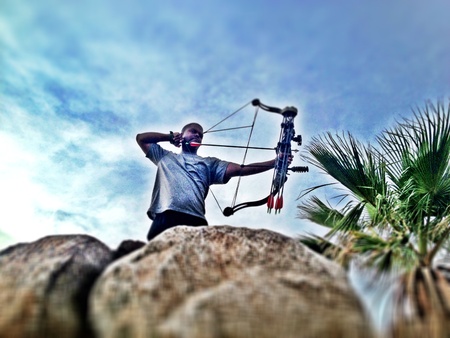 archery man holding bow and arrowの素材