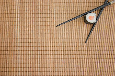 Sushi & chopsticks on a bamboo matの写真素材