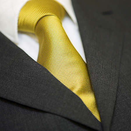 Close up of gold tie, shirt & suit - shallow depth of fieldの写真素材