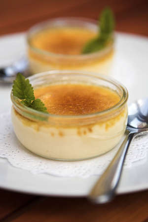 Creme brulee desserts garnished with a mint sprig - the depth of field on this image is so shallow it carries a safety notice!の写真素材