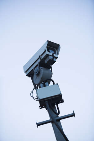 CCTV camera mounted on a pole - deliberately stark imageの写真素材
