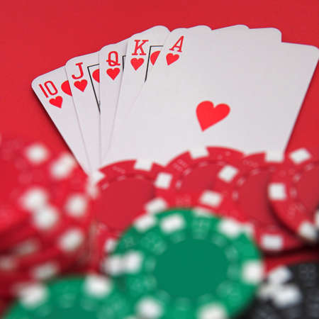 Royal flush & casino chips on red - shallow dofの写真素材