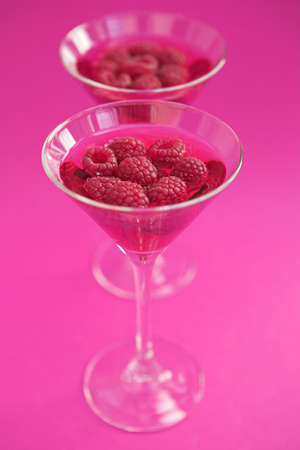 Raspberry cosmopolitan cocktails with fresh raspberry garnish- shallow dofの写真素材