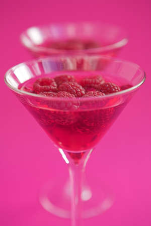 Raspberry cosmopolitan cocktails with fresh raspberry garnish- shallow dofの写真素材