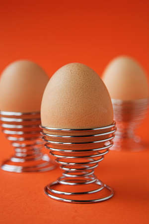 Boiled eggs on orange - shallow dofの写真素材