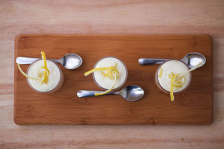 Lemon Tiramisu with lemon twists - shallow dof, tops of the desserts are in focusの写真素材