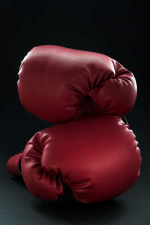 Red boxing gloves on blackの写真素材