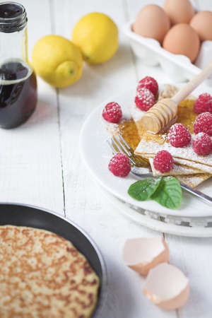 Freshly prepared crepes with raspberries - shallow dofの写真素材