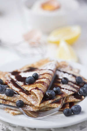 Freshly prepared crepes with blueberries & chocolate sauce - shallow dofの写真素材