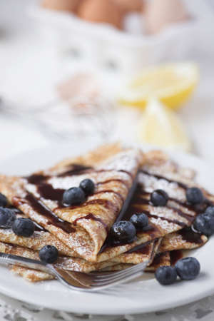 Freshly prepared crepes with blueberries & chocolate sauce - shallow dofの写真素材
