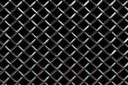 Steel grid isolated over a black backgroundの写真素材