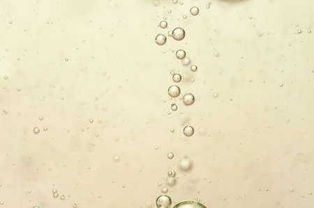 Small gas bubbles in a golden champagnの写真素材
