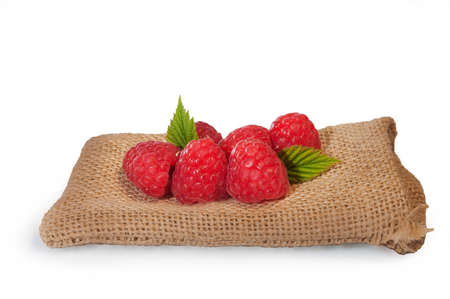 Delicious fresh raspberries laying on a canvas bagの写真素材